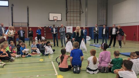 Kinder erhalten Sportbeutel des Hessischen Bewegungschecks von der hessischen Familienministerin